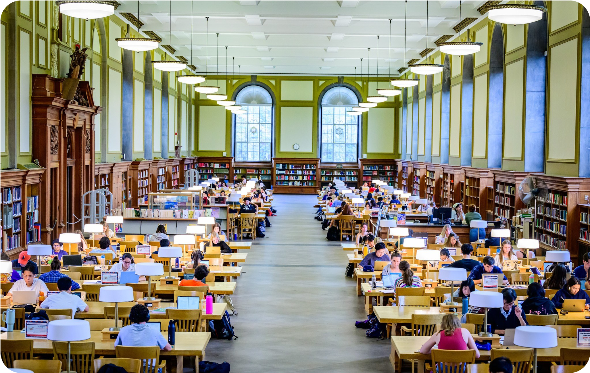 Academic library with students studying at tables